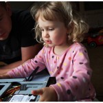 Toddler helping daddy assemble a computer