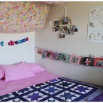 Toddler room with pink sheets, handmade quilt and lots of art projects