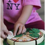 Hand sewn felt toppings on a wooden play pizza set from Melissa and Doug