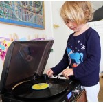 Toddler operating the record player