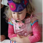 Blowing out her birthday candles at her four year old birthday party