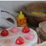 Play kitchen with wooden birthday cake, honey, bread, flours and butter